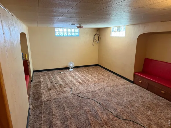 a view of an empty room with windows