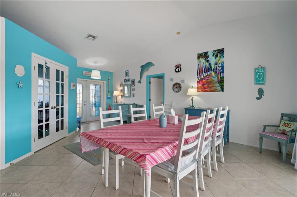 1408 Southwest 23rd Street Cape Coral, FL 33991 - Photo 14 of 49 a dining room with furniture and wooden floor