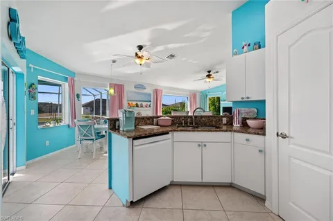 a kitchen with a sink window and cabinets