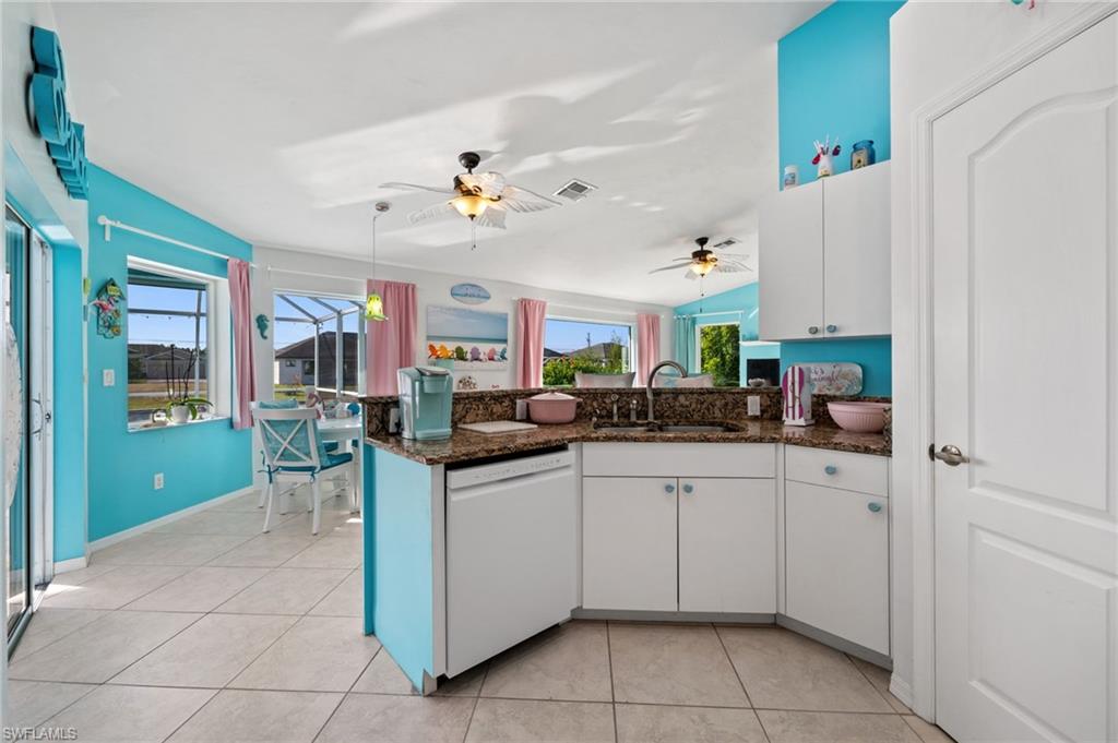 1408 Southwest 23rd Street Cape Coral, FL 33991 - Photo 16 of 49 a kitchen with a sink window and cabinets