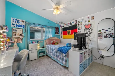 a bed room with furniture and a fan