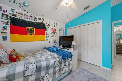 a bedroom with a bed and flat screen tv