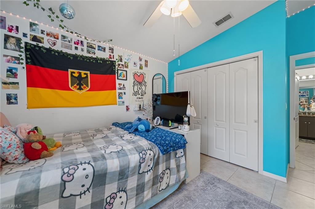 1408 Southwest 23rd Street Cape Coral, FL 33991 - Photo 26 of 49 a bedroom with a bed and flat screen tv