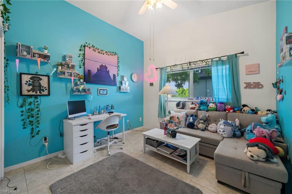 1408 Southwest 23rd Street Cape Coral, FL 33991 - Photo 27 of 49 a living room with furniture toys and a window