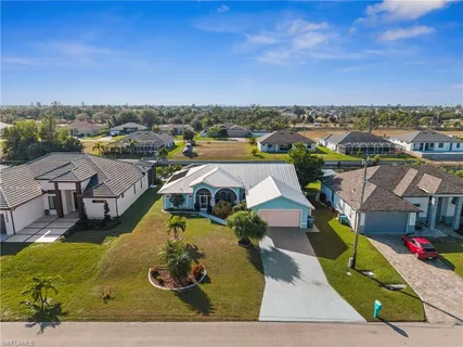 an aerial view of a house with a swimming pool
