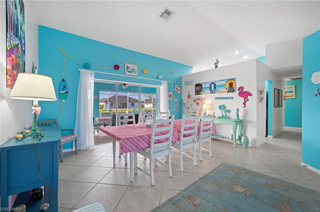 1408 Southwest 23rd Street Cape Coral, FL 33991 - Photo 34 of 49 a view of a dining room with furniture window and wooden floor