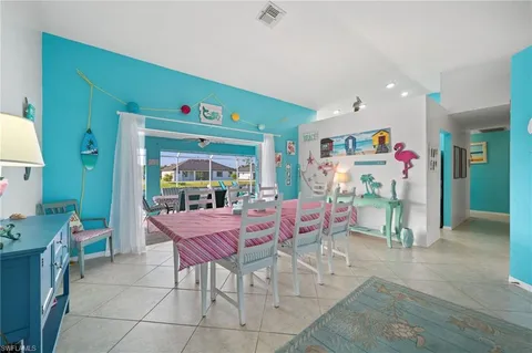 a dining room with furniture and a window