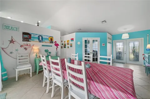 a dining room with furniture and a floor to ceiling window