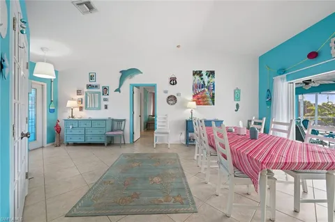 a living room with furniture and a dining table