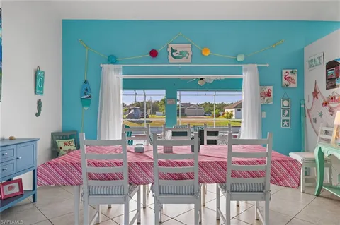 a dining room with furniture and a large window
