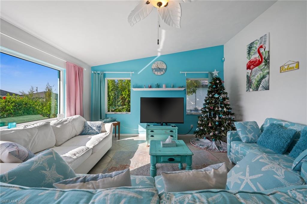 1408 Southwest 23rd Street Cape Coral, FL 33991 - Photo 41 of 49 a living room with furniture fireplace and a large window