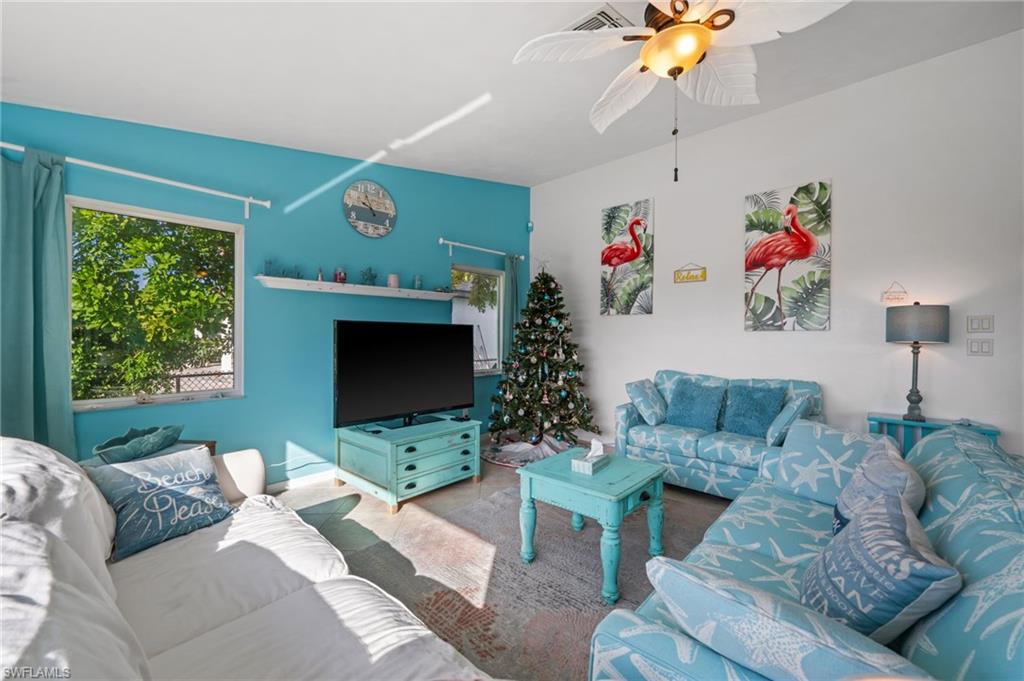 1408 Southwest 23rd Street Cape Coral, FL 33991 - Photo 42 of 49 a living room with furniture and a flat screen tv
