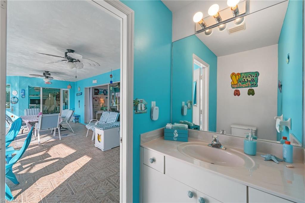 1408 Southwest 23rd Street Cape Coral, FL 33991 - Photo 44 of 49 a bathroom with a sink and a mirror