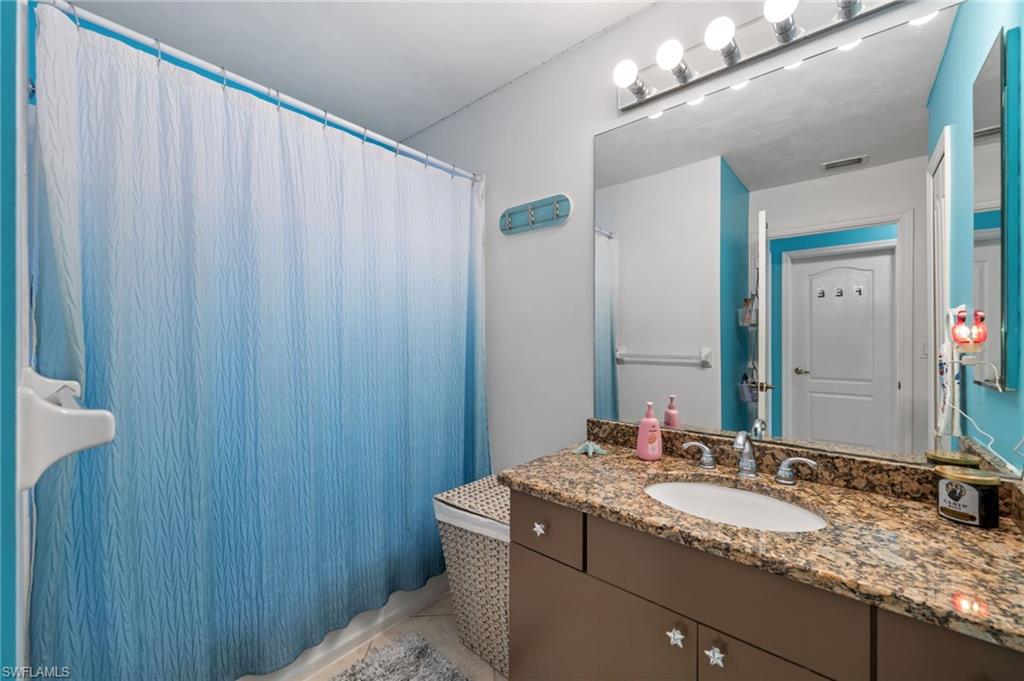 1408 Southwest 23rd Street Cape Coral, FL 33991 - Photo 45 of 49 a bathroom with a granite countertop sink and a mirror