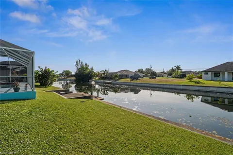 a view of swimming pool with outdoor seating and yard in back