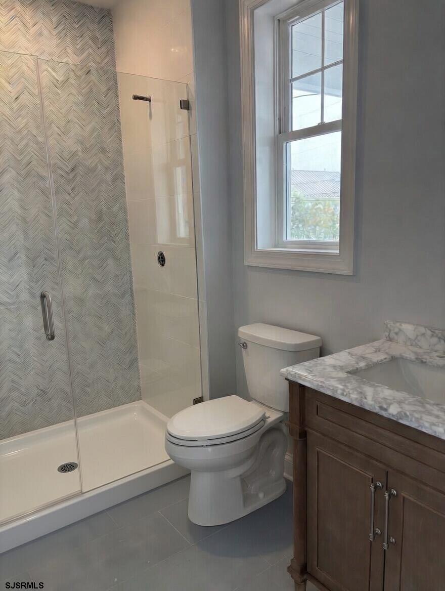140 11th Street South Brigantine, NJ 08203 - Photo 6 of 7 a bathroom with a granite countertop toilet a sink and a bathtub