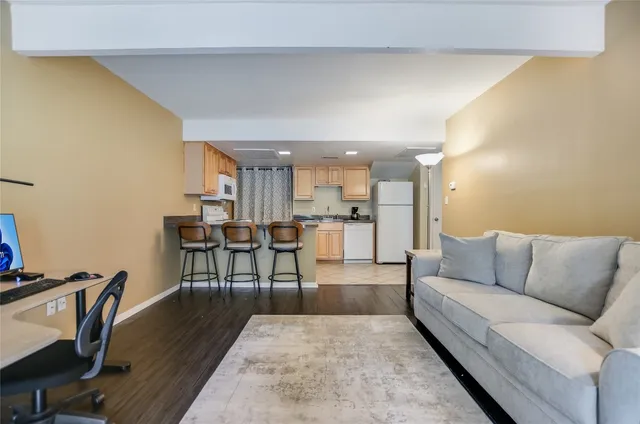 a kitchen with white cabinets appliances and a sink