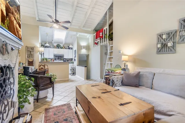 a living room with furniture and a kitchen area