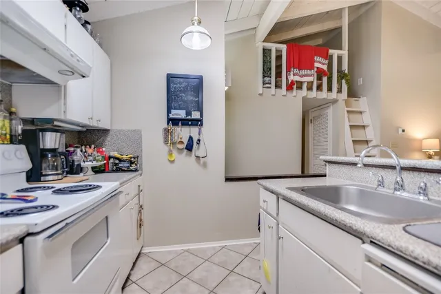 a kitchen with a sink cabinets and window
