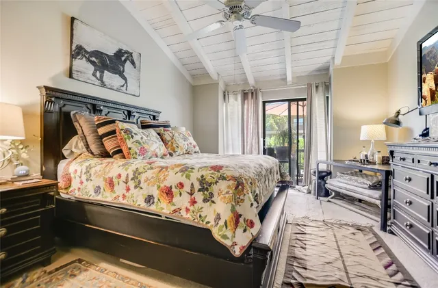a bedroom with a large bed and a chandelier