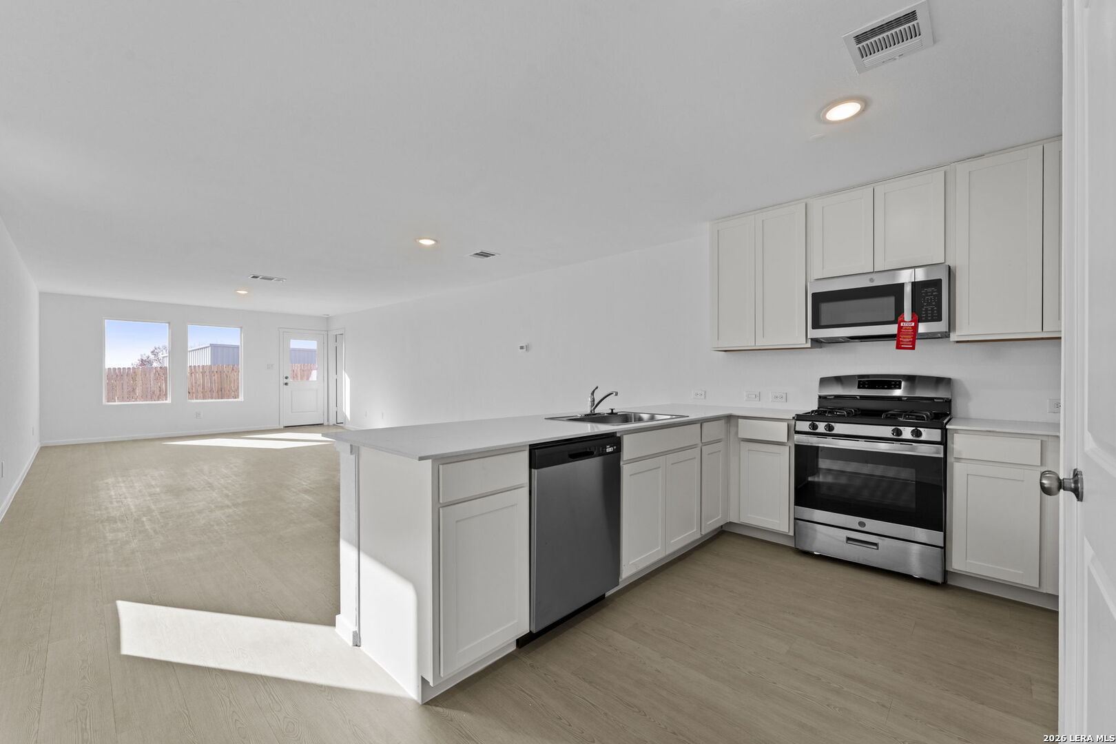 337 Kayden Court Marion, TX 78124 - Photo 13 of 25 a kitchen with granite countertop a stove top oven and cabinets