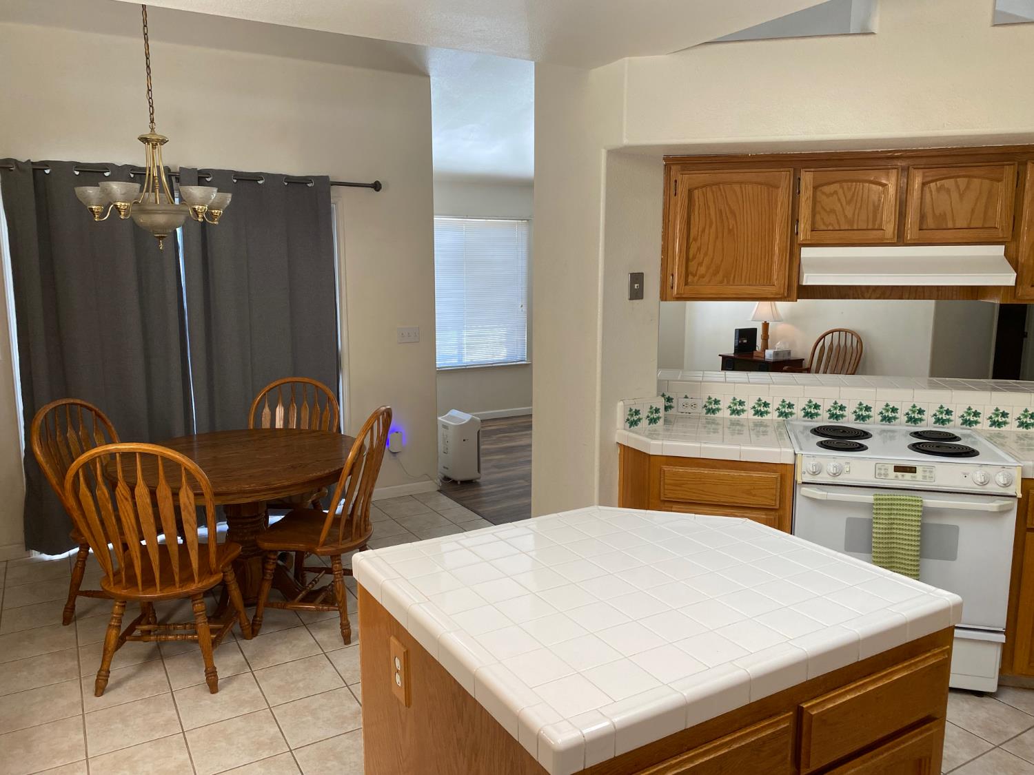 609 Merlot Avenue Madera, CA 93637 - Photo 6 of 45 a kitchen with a sink a stove and chairs