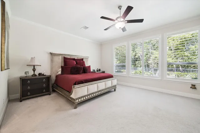 a spacious bedroom with a bed and window