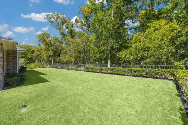 a view of a field with wooden fence