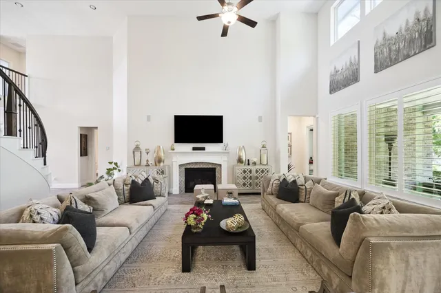 a living room with furniture a flat screen tv and a fireplace