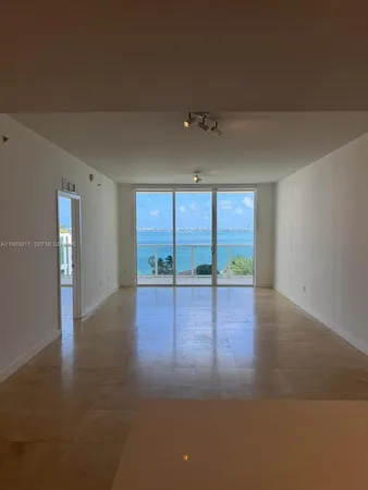 a view of room with window and wooden floor