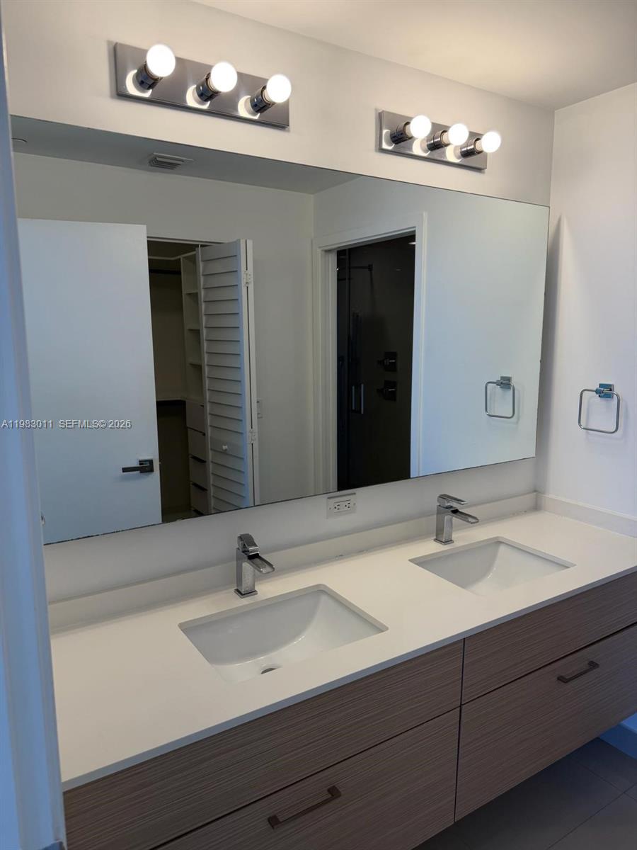 600 Northeast 27th Street, Unit 902 Miami, FL 33137 - Photo 3 of 9 a bathroom with a sink and a mirror