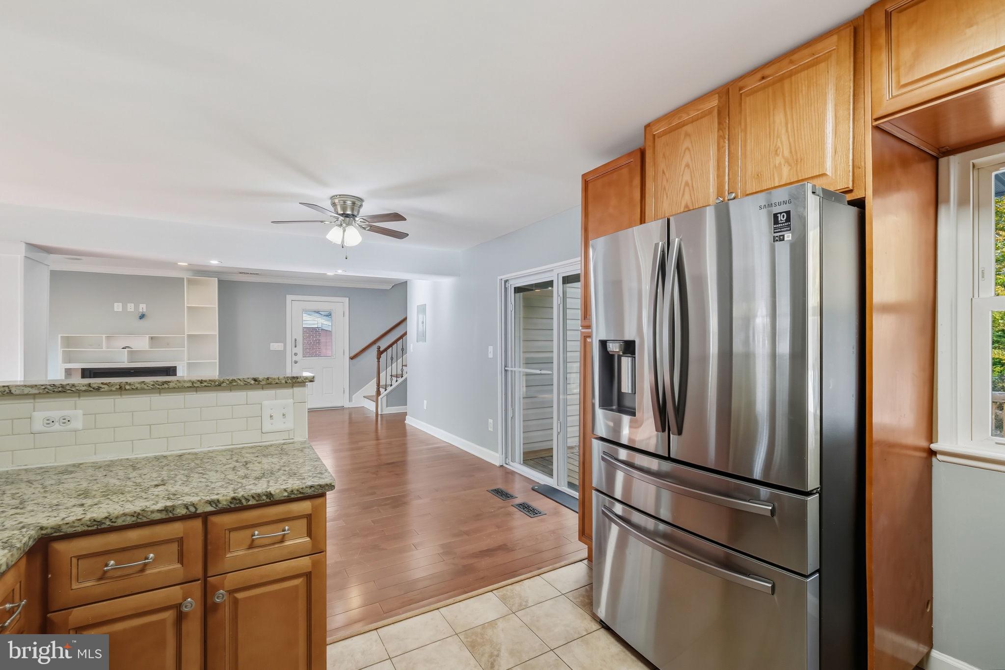 8817 Lagrange Street Lorton, VA 22079 - Photo 13 of 47 a kitchen with stainless steel appliances granite countertop a refrigerator and a stove top oven