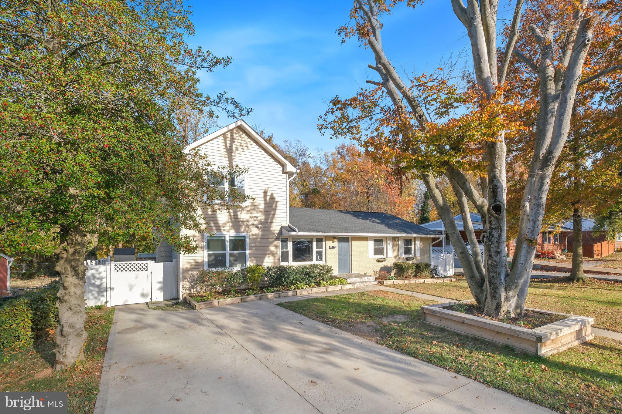 8817 Lagrange Street Lorton, VA 22079 - Photo 2 of 47 a front view of a house with a yard and tree s