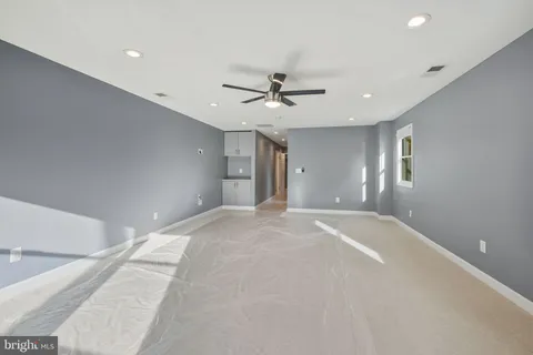 a view of a livingroom with a ceiling fan and window
