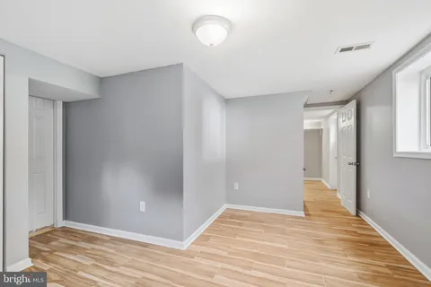 a view of an empty room with wooden floor