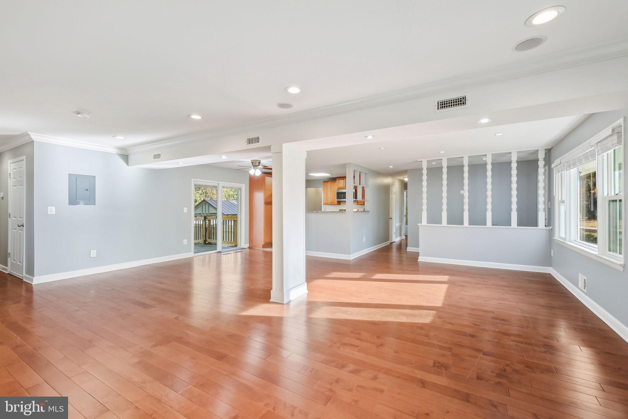 8817 Lagrange Street Lorton, VA 22079 - Photo 6 of 47 a view of an empty room with wooden floor and a window