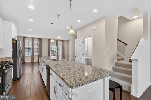 a kitchen with center island and wooden floor
