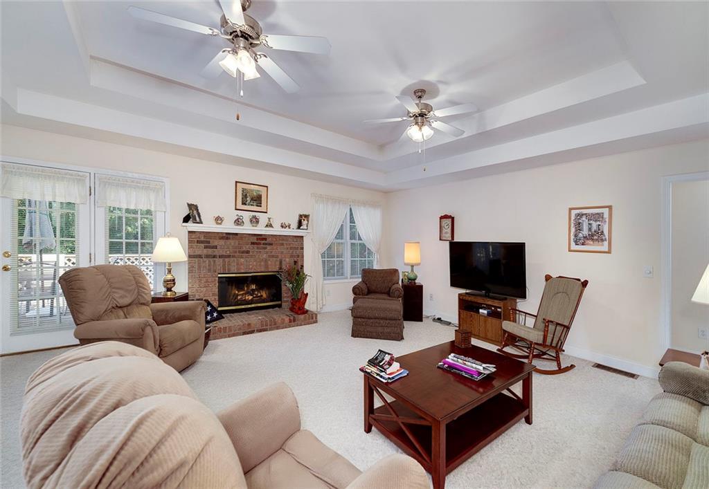 151 Courts Of Hampton Hampton, GA 30228 - Photo 15 of 54 a living room with furniture a fireplace and a flat screen tv
