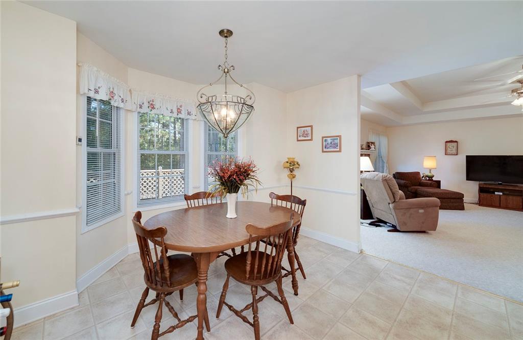151 Courts Of Hampton Hampton, GA 30228 - Photo 19 of 54 a view of a dining room with furniture wooden floor and chandelier