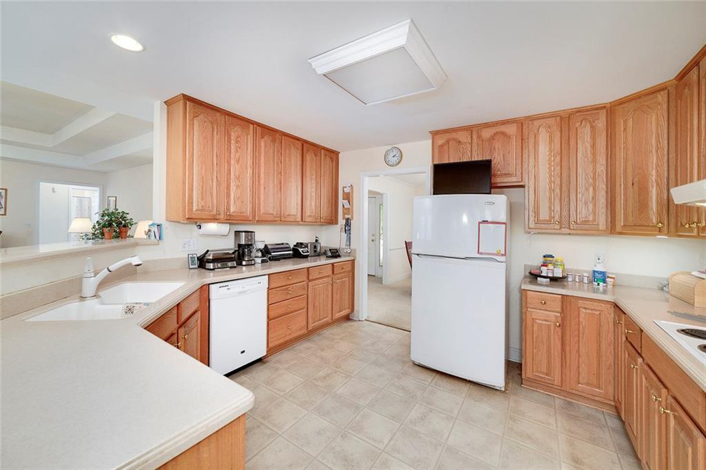 151 Courts Of Hampton Hampton, GA 30228 - Photo 24 of 54 a kitchen with stainless steel appliances granite countertop a refrigerator sink stove microwave and cabinets