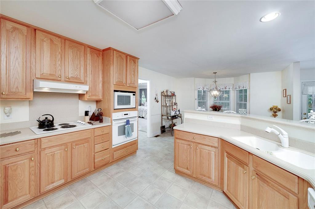 151 Courts Of Hampton Hampton, GA 30228 - Photo 27 of 54 a kitchen with lot of cabinets a sink and appliances