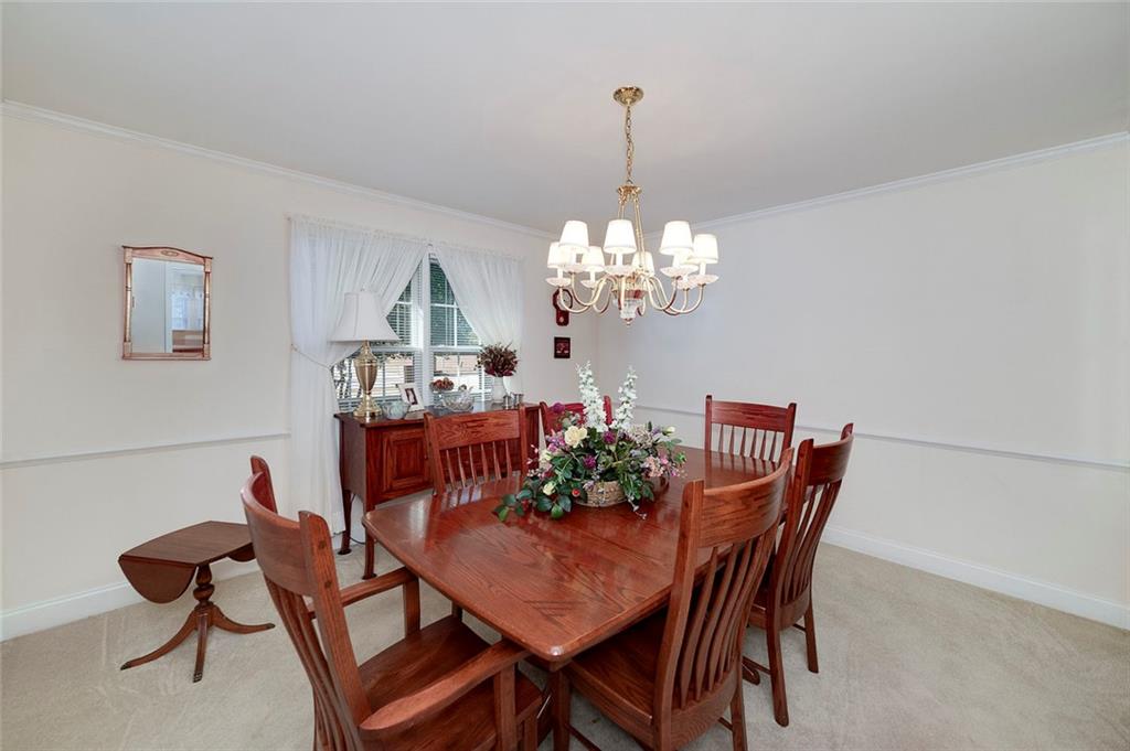 151 Courts Of Hampton Hampton, GA 30228 - Photo 28 of 54 a view of a dining room with furniture and chandelier