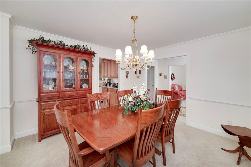 151 Courts Of Hampton Hampton, GA 30228 - Photo 29 of 54 a view of a dining room with furniture and chandelier