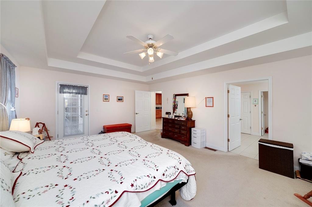 151 Courts Of Hampton Hampton, GA 30228 - Photo 31 of 54 a bedroom with a bed and dresser with mirror