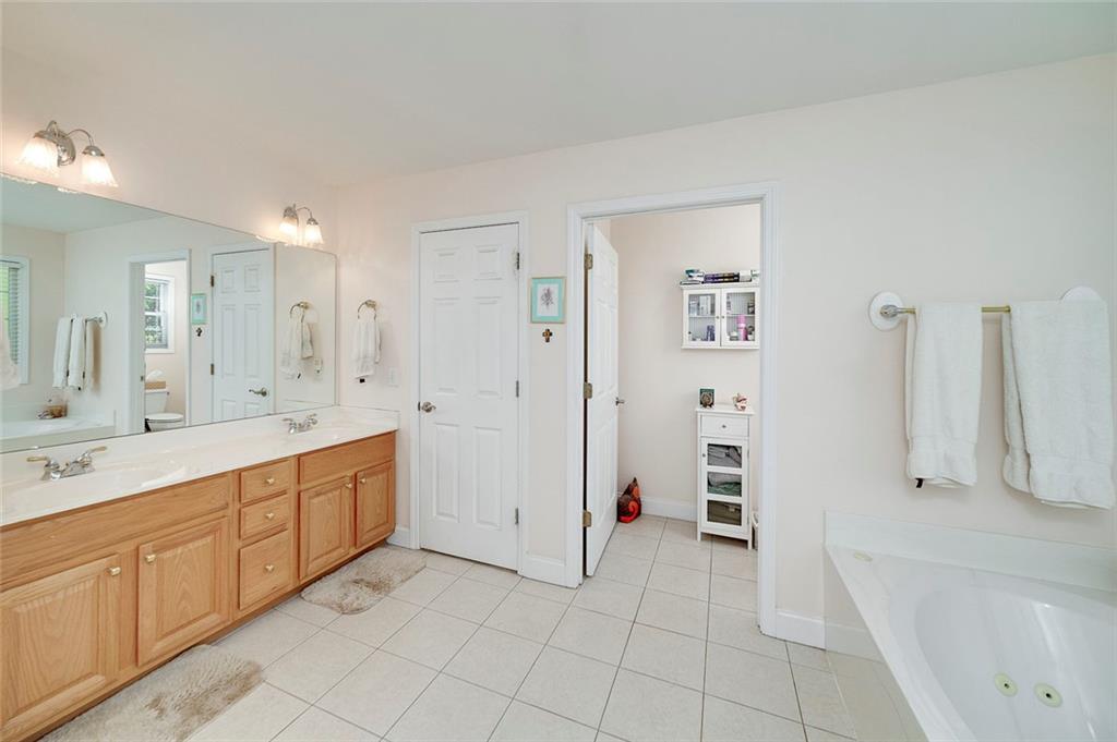 151 Courts Of Hampton Hampton, GA 30228 - Photo 32 of 54 a spacious bathroom with a double vanity sink a mirror and a bathtub