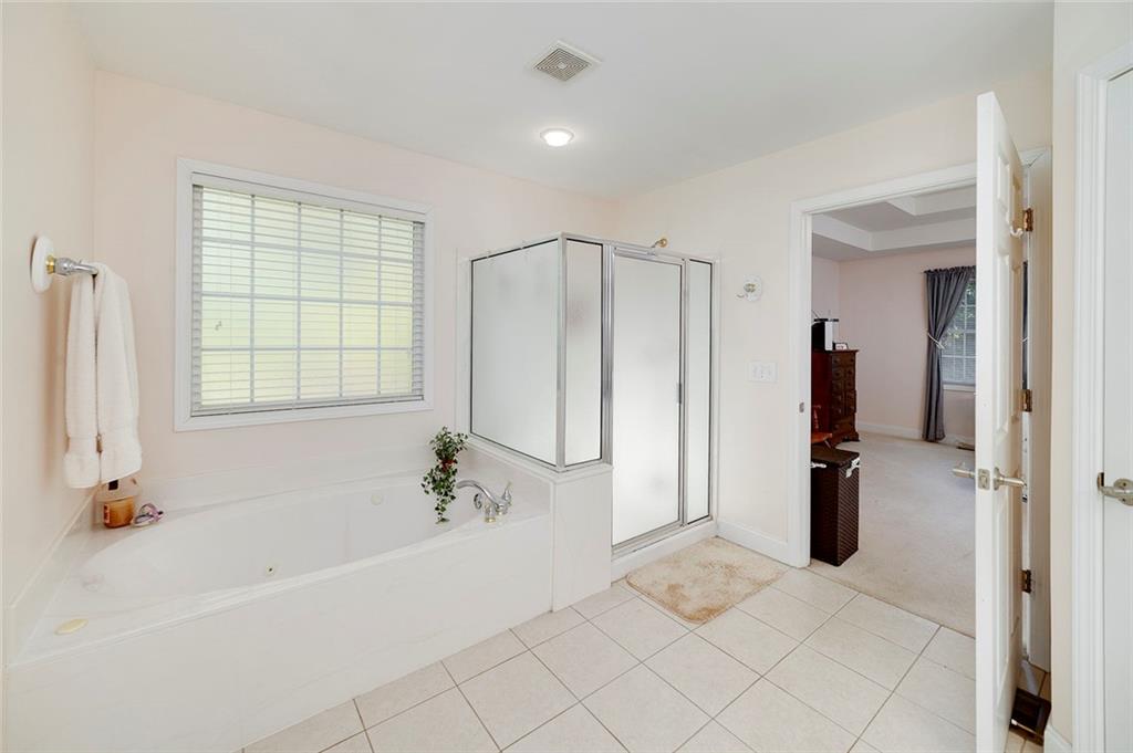 151 Courts Of Hampton Hampton, GA 30228 - Photo 33 of 54 a spacious bathroom with a tub shower and a sink
