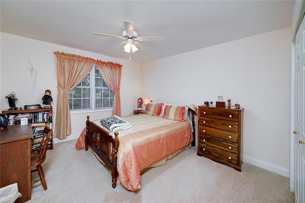 151 Courts Of Hampton Hampton, GA 30228 - Photo 36 of 54 a bedroom with a bed and a chandelier