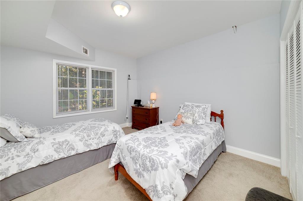 151 Courts Of Hampton Hampton, GA 30228 - Photo 42 of 54 a bedroom with a bed and wooden floor