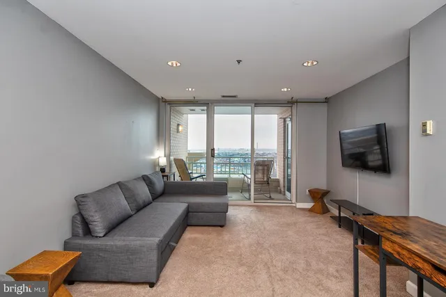 a living room with furniture and a large window