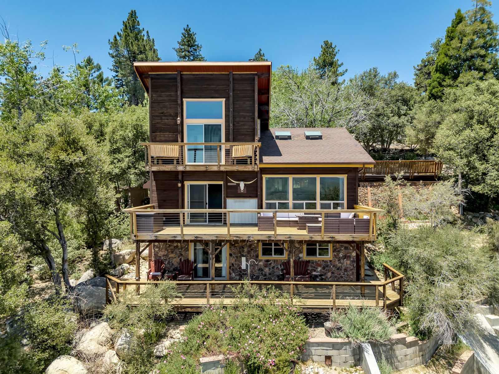 a aerial view of a house with swimming pool and sitting area